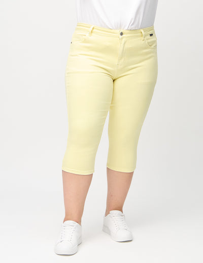 Lysegule skinny capris, modelnavn Lemonades, som sidder tæt til benet på en plus-size model, set forfra.